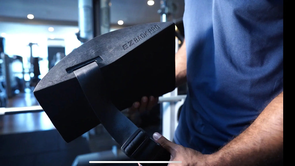 Anthony Nitti holding the EZBack Pro Level 2 strap, showcasing the intermediate-level posture support tool for performance and spinal alignment.