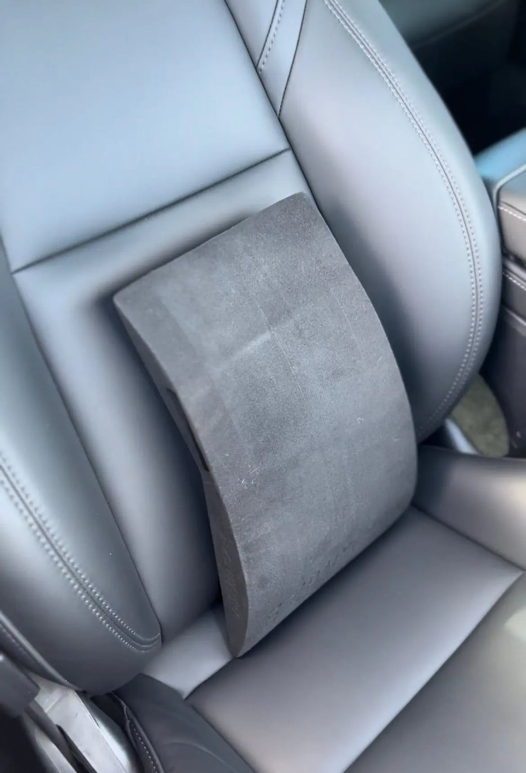 EZBack Pro Level 1 strap placed on a Tesla car seat to provide lumbar support and improve posture during driving